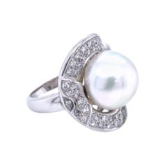 A magnificent 18k white Gold ring set with a South Sea Pearl 13mm and Sparkling round brilliant cut Diamonds 1.25 cts. G Color Vvs Clarity Circa 1970 CONDITION: Pre-owned - Excellent METAL: 18k Gold GEM STONE: Diamonds - Pearl WEIGHT: 14.70 grams RING SIZE: US 7.5 - IT 16 - FR 56 - UK P. We are happy to resize the ring to whatever finger size is required for no additional charge. * every jewel we propose for sale is professionally tested by our internal gemological team of specialist I.G.I./HRD Sapphire Cocktail Ring, White Gold Diamond Earrings, Vintage Cocktail Ring, Platinum Diamond Rings, White Gold Set, Gold Cocktail Ring, Gold Cocktail, Gold Diamond Necklace, Diamond Cocktail Rings