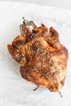 a piece of meat on top of a white paper with a bottle opener in the middle