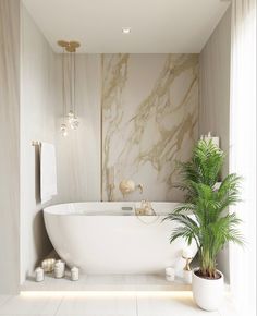 a white bath tub sitting next to a green plant in a bathroom under a window