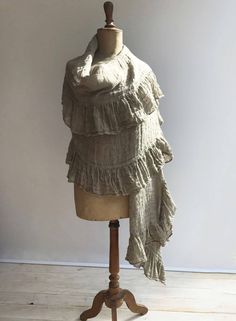 "This is a fantastic, generously sized linen shawl with an elegant ruffle along all sides. Made from gauzy, 100% pure natural taupe linen. Gorgeous texture and distinct wrinkling. Rustic texture combined with feminine styling. A great accessory that will prove itself a timeless value. The dimensions approximately 87\" x 31.5\" (220cm x 80 cm) The shawl will be pre-washed and won't shrink anymore. Care instructions: - machine washable in gentle wash cycle - preferably lukewarm water - straighten Bohemian Linen Shawl, Beige Linen Bohemian Scarf, Bohemian Beige Linen Scarf, Bohemian Linen Shawl Scarf, Shawl Wedding, Linen Scarf, Rustic Texture, Linen Scarves, Wedding Shawl