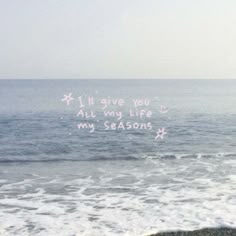 a message written on the sand next to the ocean