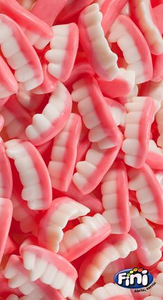 pink and white gummy teeth are piled together