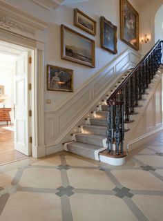 a staircase with pictures on the wall next to it