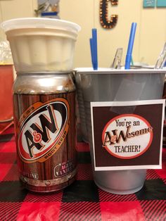 there is a coffee cup next to an ice cream container and a sign on the table that says, you're an awesome teacher