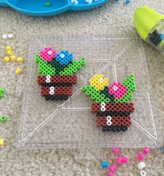 two legos made to look like flowerpots sitting on the floor