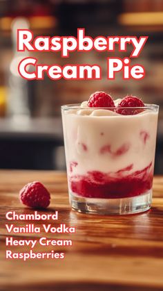 raspberry cream pie in a small glass dish on a wooden table with the words raspberry cream pie above it