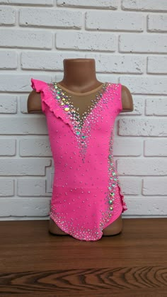 a pink leotard top with sequins on it