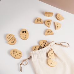 wooden emoticions are arranged on a white surface