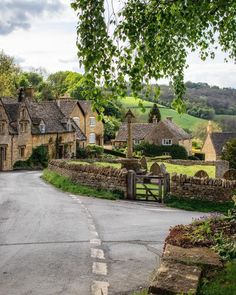 an old country road with stone houses on either side