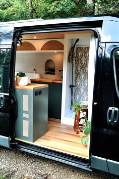 an open van door showing the kitchen and living area