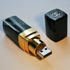 a black and gold lighter next to it's holder