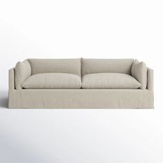 a white couch sitting on top of a white floor