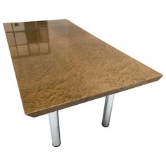 a wooden table with metal legs on a white background