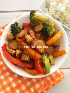 a white bowl filled with vegetables next to rice