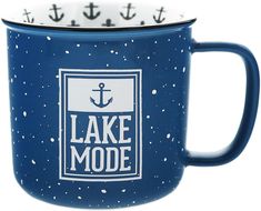 a blue and white coffee mug with an anchor on the side that says lake mode