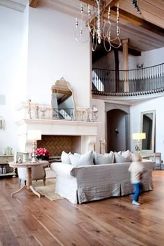 a living room filled with furniture and a chandelier