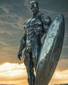 a statue of a man holding a surfboard in front of the sun setting behind him