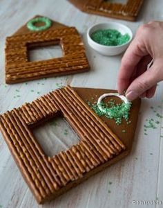 someone is decorating some cookies with green icing