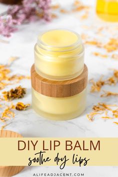 DIY lip balm in frosted glass jar with a bamboo wood lid. It's surrounded by decorative calendula flowers. Text overlay: DIY lip balm to soothe dry lips. Calendula Infused Oil, Homemade Lip Balm Recipe, Lip Balm Recipe, Homemade Lotion Bars, Balm Recipe, Peppermint Lip Balm, Honey Packaging, Infused Oil