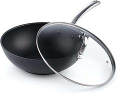 an empty frying pan with a lid on the side and another one in the middle