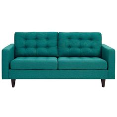 a teal colored couch sitting on top of a white floor