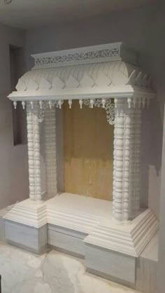 a white gazebo in the middle of a room with marble flooring and walls