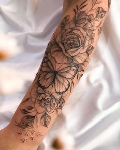 a woman's arm with flowers on it