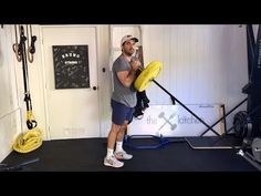 a man holding a yellow frisbee in front of a gym equipment set up