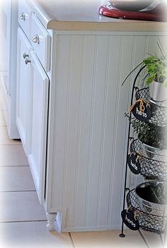 a kitchen with a sink, dishwasher and potted plant on the counter