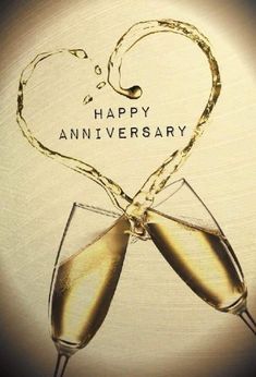 two glasses of champagne with the words happy anniversary written on them