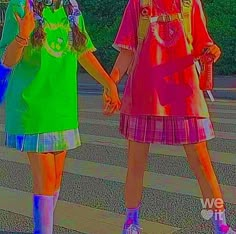 two girls are walking down the street holding hands and one is wearing bright colored clothing