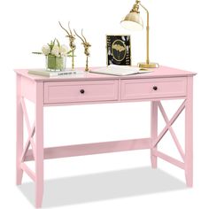 a pink desk with two drawers and a lamp