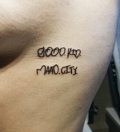 a tattoo that reads good, bad and maq city on the side of a man's stomach