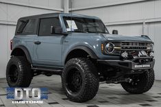 a large blue truck parked in a garage