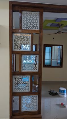 the inside of a room with several shelves and tools on the floor in front of it