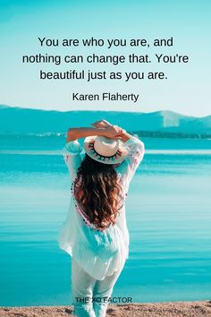 a woman standing on top of a beach next to the ocean with a quote above her that reads, you are who you are, and nothing can change that you