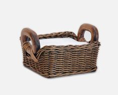 a wicker basket with wooden handles on a white background