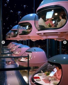 people are sitting at a table in a futuristic restaurant