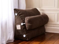 a brown pillow sitting on top of a wooden floor