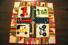 a quilted table runner with cars and trucks on it