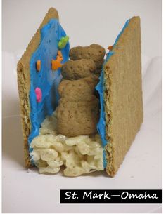 a piece of bread with blue icing and some cookies in it