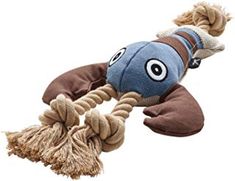 a stuffed animal toy that looks like a fish on a rope with eyeballs and tassels