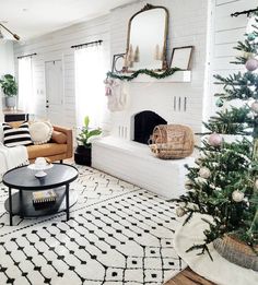 a living room decorated for christmas with white walls