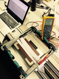 an open laptop computer sitting on top of a table next to a calculator