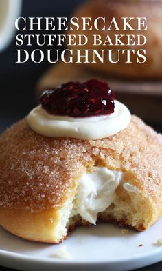 a close up of a pastry on a plate with the words cheesecake stuffed baked doughnuts