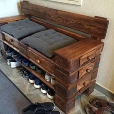 a wooden bench with several pairs of shoes on the bottom shelf and one pair of flip flops sitting next to it