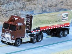 a toy semi truck is shown on the track