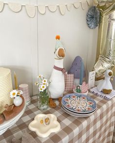 a table topped with lots of cakes and desserts next to a cake plate covered in flowers