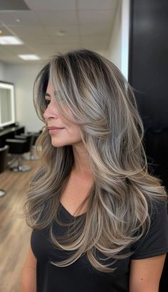 Gray hair is a natural part of aging, but it doesn't mean you have to settle for dull or uninspired hairstyles. In fact, with the right cut and style, gray hair can look incredibly chic Hairstyle For Women Over 40 Long, Dark Blonde Grey Blending, Gray Long Hair Older Women, Hair Colors For 45 Year Old Women, Blonde Hair For Older Women Over 50 Long Hairstyles, Layered Ash Brown Hair, Best Highlights For Greying Hair, Ash Blonde Layered Hair, Long Layered Grey Hair