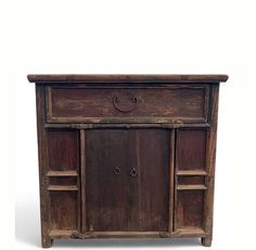 an old wooden cabinet with two doors on the front and one door open to reveal a drawer